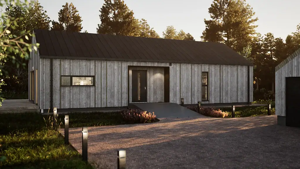 Modulpluss Sør, moderne prefabrikkert hytte i tre med svart tak, omgitt av natur og opplyste veibelysning, ideell for bærekraftige husløsninger og modulbygg.
